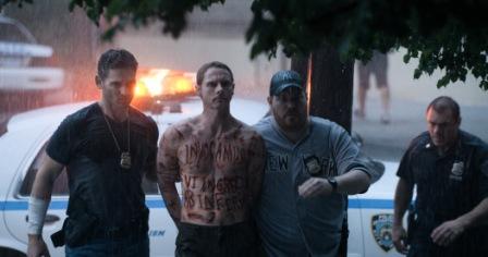 Sarchie (Eric Bana) brings in Santino (Sean Harris) with other officers in Screen Gems' DELIVER US FROM EVIL.