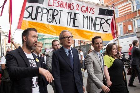 British actors Bill Nighy, center, Andrew Scott, center right, and Paddy Considine, center left, walk in front of banners from the film 'Pride', from the photo call at the Electric Ballroom to the premiere at Camden's Odeon cinema, north London, England, Tuesday, Sept. 2, 2014. (Photo by Joel Ryan/Invision/AP) -
